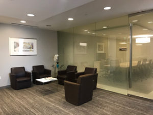 Glendale office waiting room, large glass window, five brown chairs