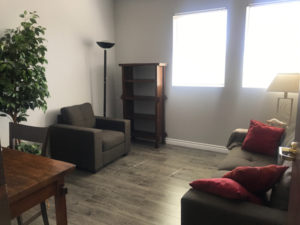 Woodland Hills Office, tan sofa, bookshelf, two chairs