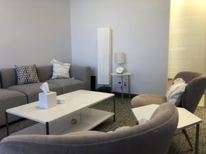 sherman oaks suite 1208, room 3, large grey sofa, white table