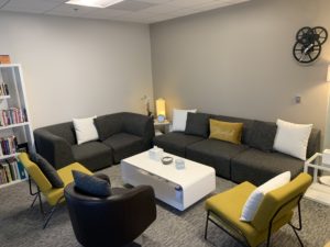 sherman oaks suite 1208, room 6, two large grey sofas, two yellow chairs