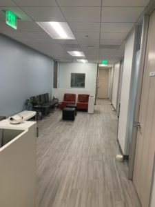 sherman oaks waiting room suite 1208 white reception desk, white bench, brown chairs, burgundy chairs