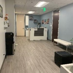 sherman oaks waiting room suite 1208 white reception desk, white bench