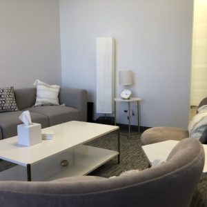 sherman oaks suite 1208, room 3, large grey sofa, white table