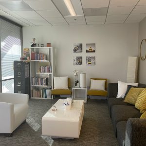sherman oaks suite 1208, room 6, two large grey sofas, two yellow chairs