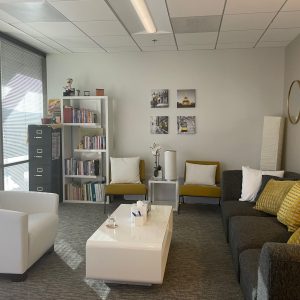 sherman oaks suite 1208, room 6, two large grey sofas, two yellow chairs