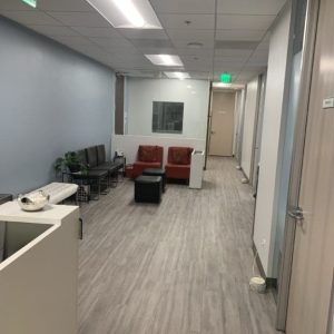 sherman oaks waiting room suite 1208 white reception desk, white bench, brown chairs, burgundy chairs