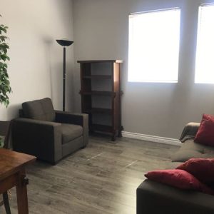 Woodland Hills Office, tan sofa, bookshelf, two chairs